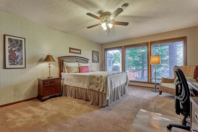 A second guest bedroom also features large windows overlooking the lake. | Image 33