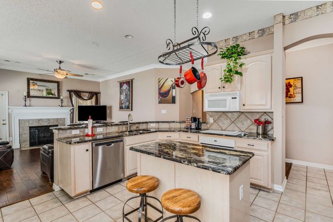 Kitchen featuring appliances, a sink, pot a peninsula, and open floor plan | Image 12