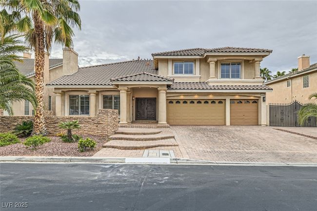 Mediterranean / spanish-style house featuring stucco siding, a tiled roof, a garage, and decorative driveway | Image 7
