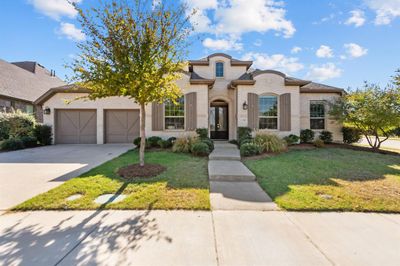 Mediterranean / spanish house featuring a front lawn and a garage | Image 2