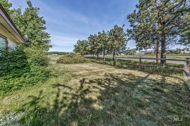 Fenced backyard with a view of rural / pastoral area | Image 42