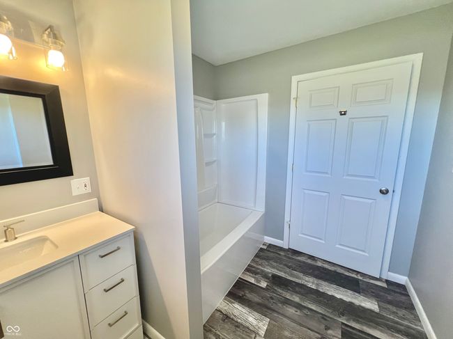 full bath with wood finished floors, vanity, and baseboards | Image 16