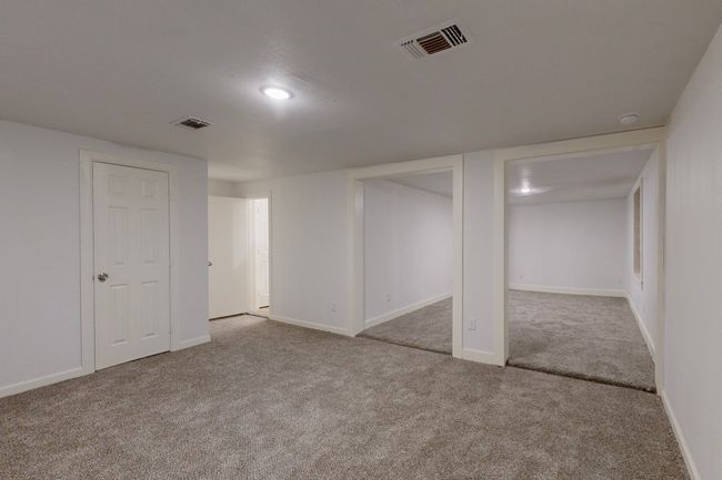 Basement featuring light colored carpet | Image 17