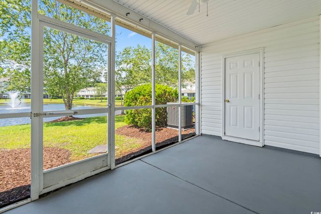 Unfurnished sunroom with a water view and a ceiling fan | Image 22