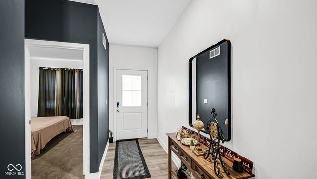 foyer entrance featuring light wood-style flooring and baseboards | Image 11
