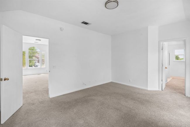Empty room with visible vents, carpet, plenty of natural light, and baseboards | Image 19
