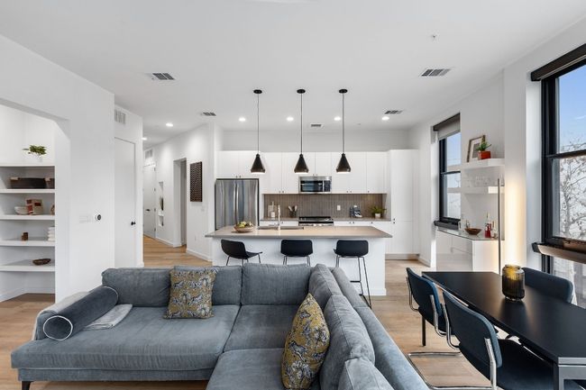 Spacious living areas that are bathed in natural light and overlook the quiet side of this building | Image 10