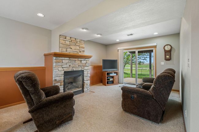 908 24th Ave NW - wonderful lower level walkout family room; gas fireplace has attractive stacked rock design | Image 13
