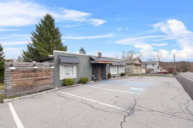 Uncovered parking lot featuring fence | Image 22