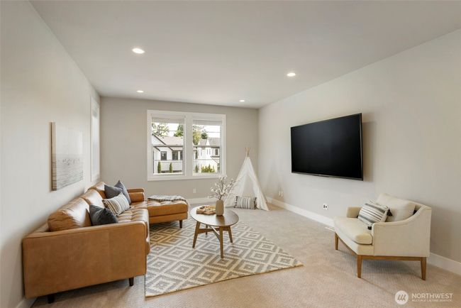 Located at the top of the stairs, this spacious bonus room is perfect as a media lounge, playroom, or flex space to fit your lifestyle. With plush carpeting, ample natural light, and room to spread out, it’s a comfortable and versatile retreat for the whole household. | Image 25