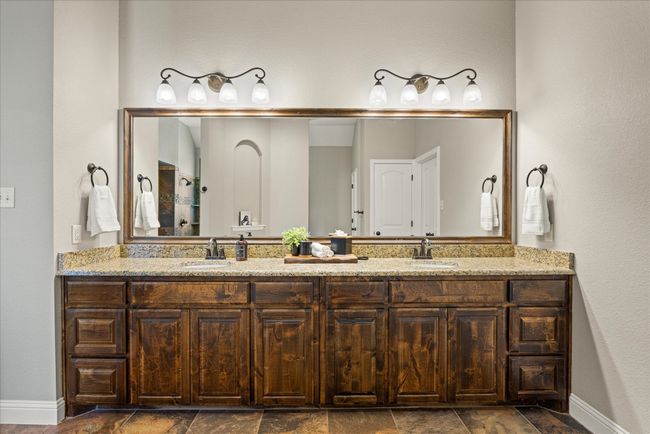 Bathroom featuring double vanity and stone finish flooring | Image 24