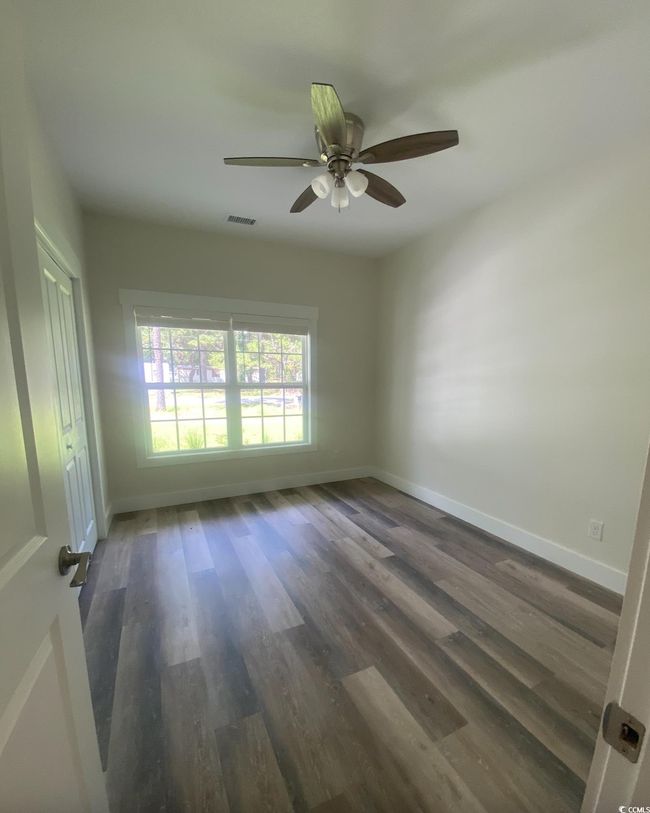Unfurnished room with wood finished floors and ceiling fan | Image 23