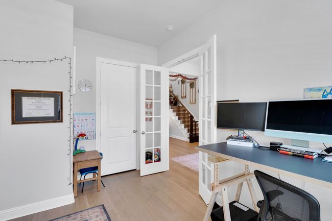 Office with light wood-style floors and french doors | Image 31