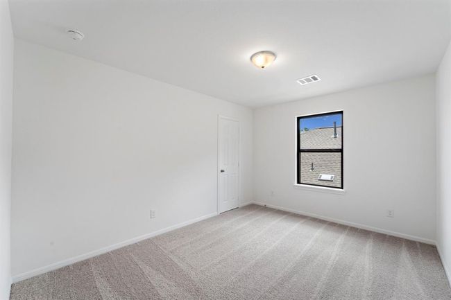 Your secondary bedroom features plush carpet, fresh paint, closet, and a large window that lets in plenty of natural lighting. | Image 18