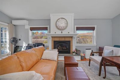 Living room features a gas fireplace and plenty of windows for natural light and great views! | Image 3