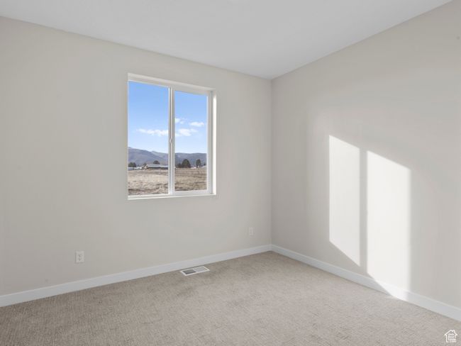 Unfurnished room with visible vents, light carpet, a mountain view, and baseboards | Image 15