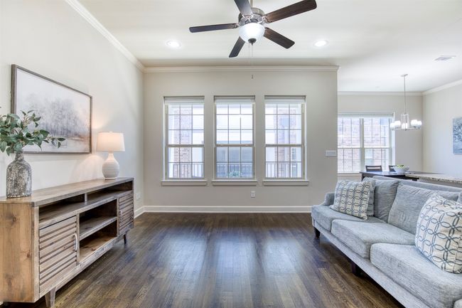 Living room with wall of windows overlooking balcony. | Image 5
