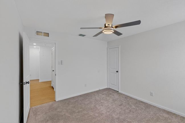 Unfurnished bedroom featuring carpet floors, baseboards, and a ceiling fan | Image 30