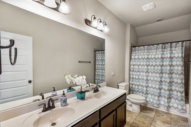 A modern bathroom featuring a sink, a shower, a to | Image 43