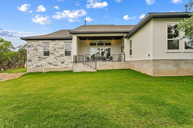Back of property with a yard, ceiling fan, stone siding, and stucco​​‌​​​​‌​​‌‌​‌‌​​​‌‌​​‌‌​‌​​​​​‌ siding | Image 30