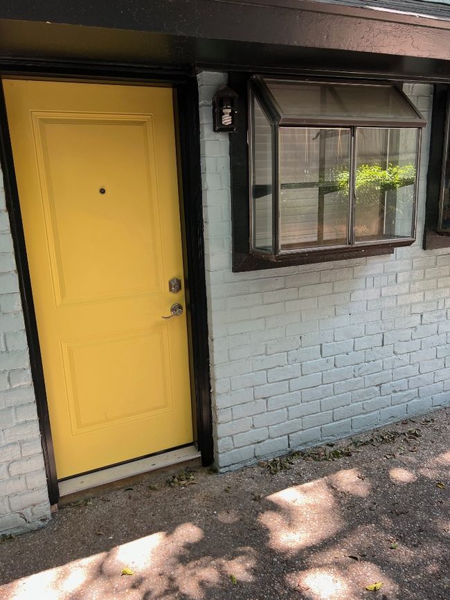 View of exterior entry with brick siding | Image 23