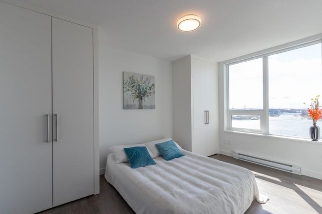 Bedroom featuring baseboards, wood finished floors, and a baseboard radiator | Image 5