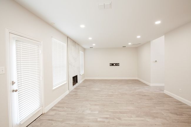 Basement featuring recessed lighting, a fireplace, and light wood-style flooring | Image 14