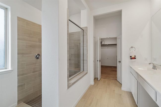 The bathroom leads right into a large closet space. | Image 26