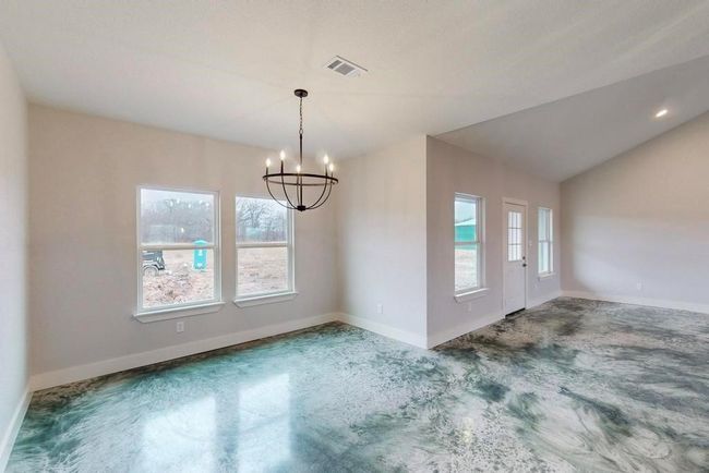Unfurnished dining area featuring visible vents, baseboards, carpet flooring, and a notable chandelier | Image 5