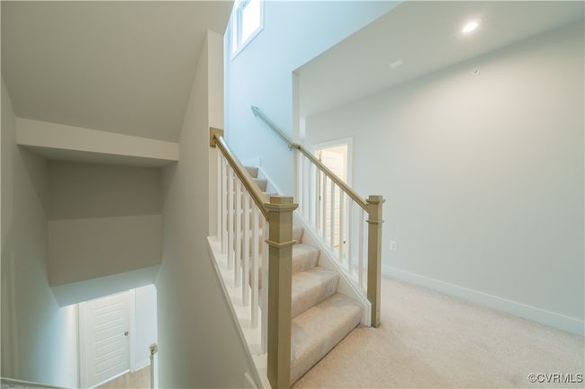 Stairway featuring carpet floors, baseboards, and recessed lighting | Image 26