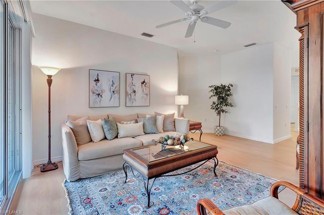 Living room featuring light wood-type flooring and ceiling fan | Image 6