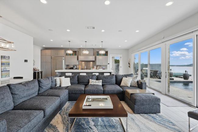 Living room with a water view, recessed lighting, and visible vents | Image 24
