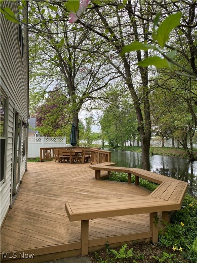 Deck with a water view and outdoor dining area | Image 7