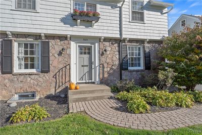 The brick paver walkway leads to the front door and main entrance to the home. The exterior is bright and cheery having been freshly painted this last year, as well as new gutters added along the front. | Image 2