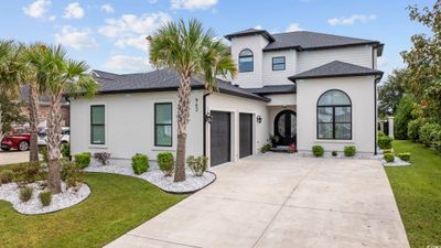 View of front of property featuring a front yard and a garage | Image 1