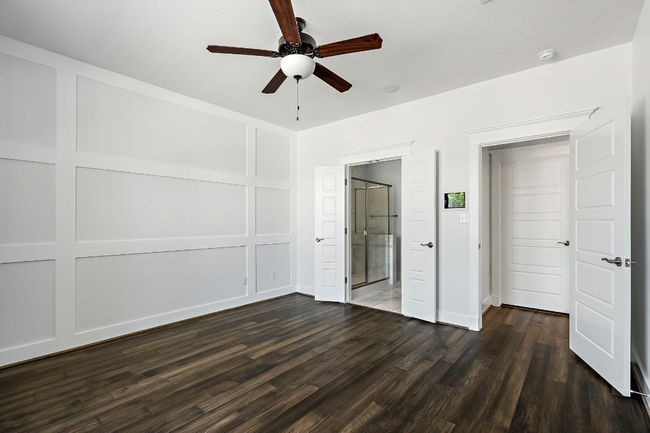 Unfurnished bedroom with dark wood-style floors, ceiling fan, and baseboards | Image 18