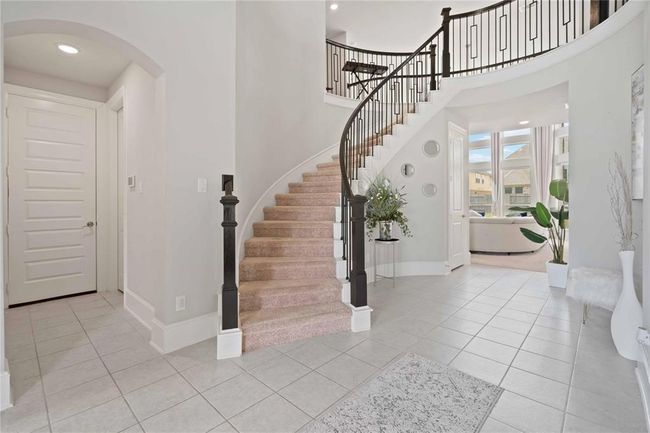 stairs coming down to foyer at entrance of home | Image 6