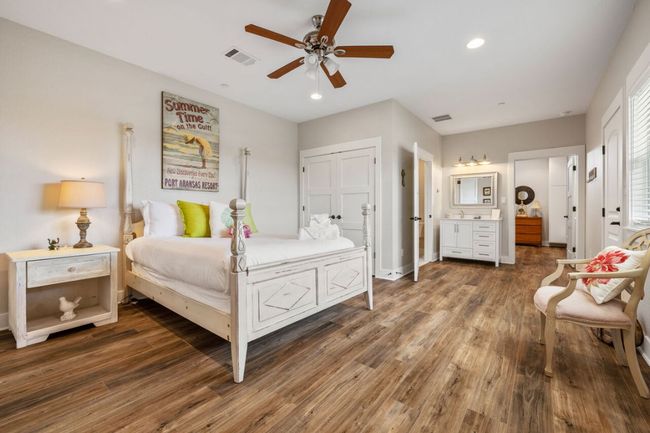 Bedroom featuring wood finished floors, recessed lighting, connected bathroom, ceiling fan, and baseboards | Image 35