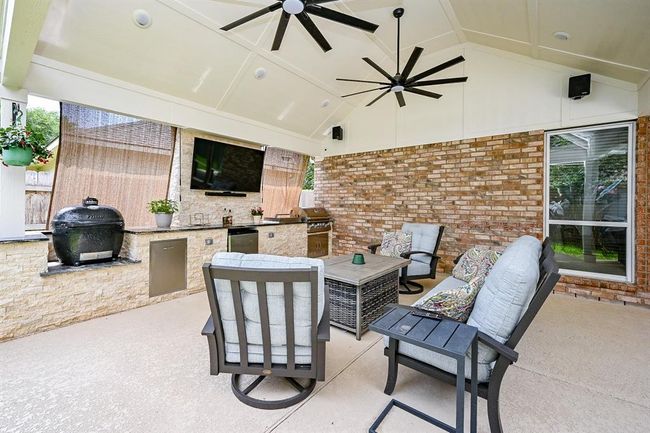 A built-in grill, side burner, mini fridge and prep area add to the functionality of this backyard oasis. | Image 5
