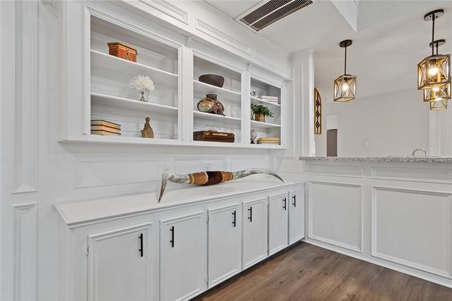 The other end of the family room boasts built-in bookshelves. | Image 14