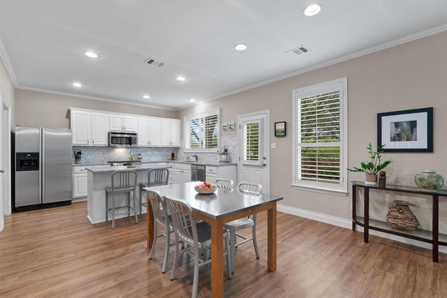 Dining space featuring ornamental molding, light wood finished floors, recessed lighting, and baseboards | Image 8