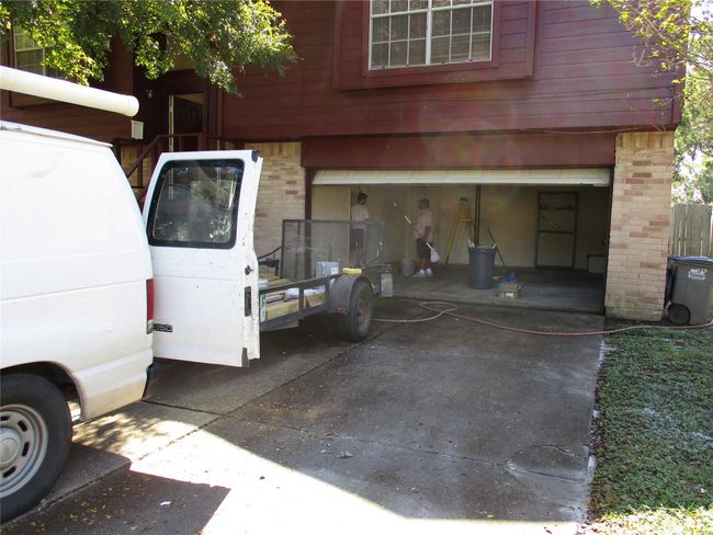large 2 car wide driveway and garage offers plenty of parking and storage space. Some shelving in the garage as well. | Image 26