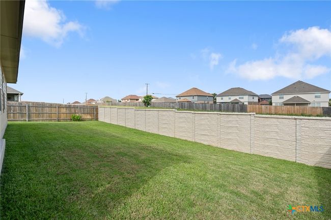 Large backyard with stone wall for privacy | Image 23