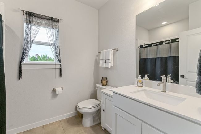 Full bath featuring vanity, tile patterned floors, and a shower with curtain | Image 32