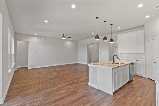 Kitchen featuring dark wood-style flooring, baseboards, a ceiling fan, and dishwasher | Image 5