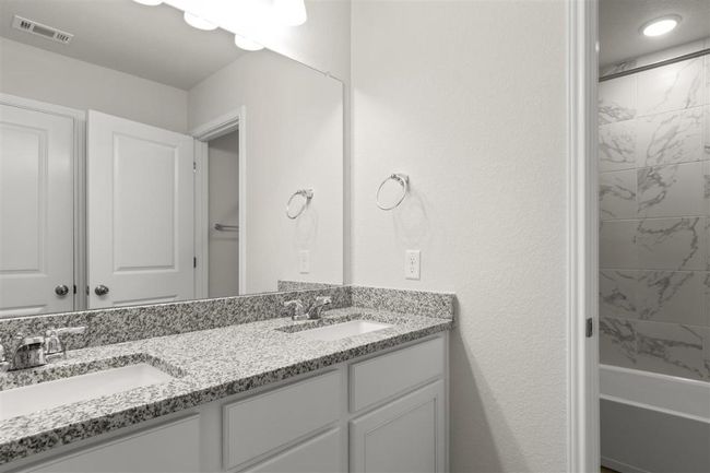 Bathroom featuring double vanity, a sink, and visible vents | Image 24