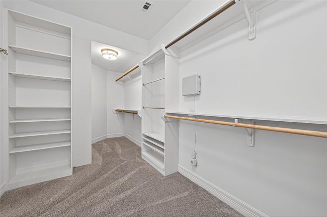 Your carefully throughout and designed walk-in closet with custom built-ins featuring plenty of shelves and variety to satisfy any want or need you ever desired when it comes to organization. | Image 25