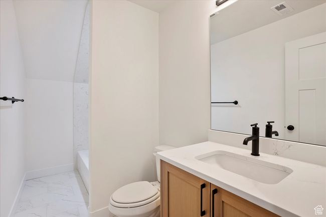 Full bathroom featuring vanity, marble finish floor, baseboards, toilet, and visible vents | Image 16