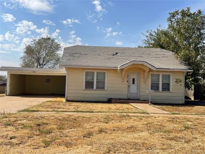 Single story home featuring a carport and a front yard | Image 1