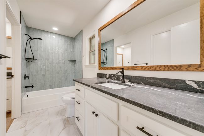 Bathroom featuring vanity, tub / shower combination, recessed lighting, and marble finish flooring | Image 20
